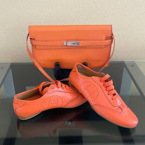 Orange crossbody purse with matching sneakers